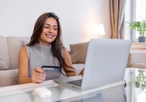 Candidate studying on a couch with a laptop